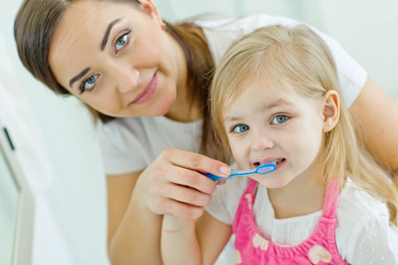 Mom and Daughter Brushing Their Teeth