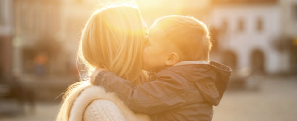 child with liptie hugs mother