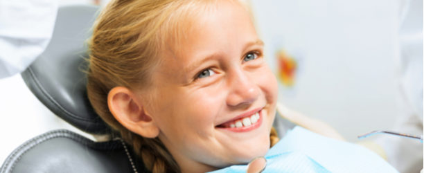 girl smiling in dental chair