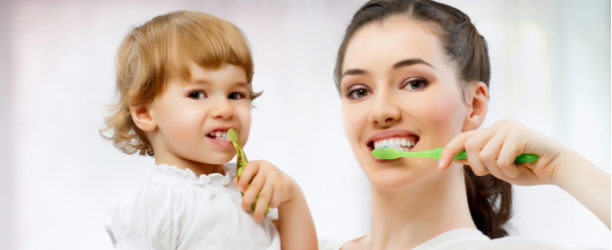 mom and child brushing teeth